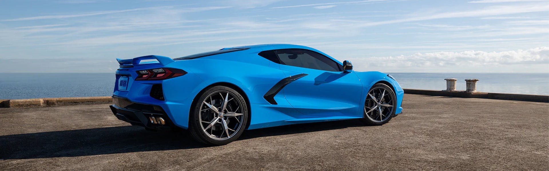 A Sky blue corvette car parked near lake