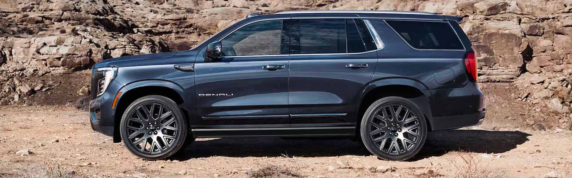 A black SUV stands Left side view